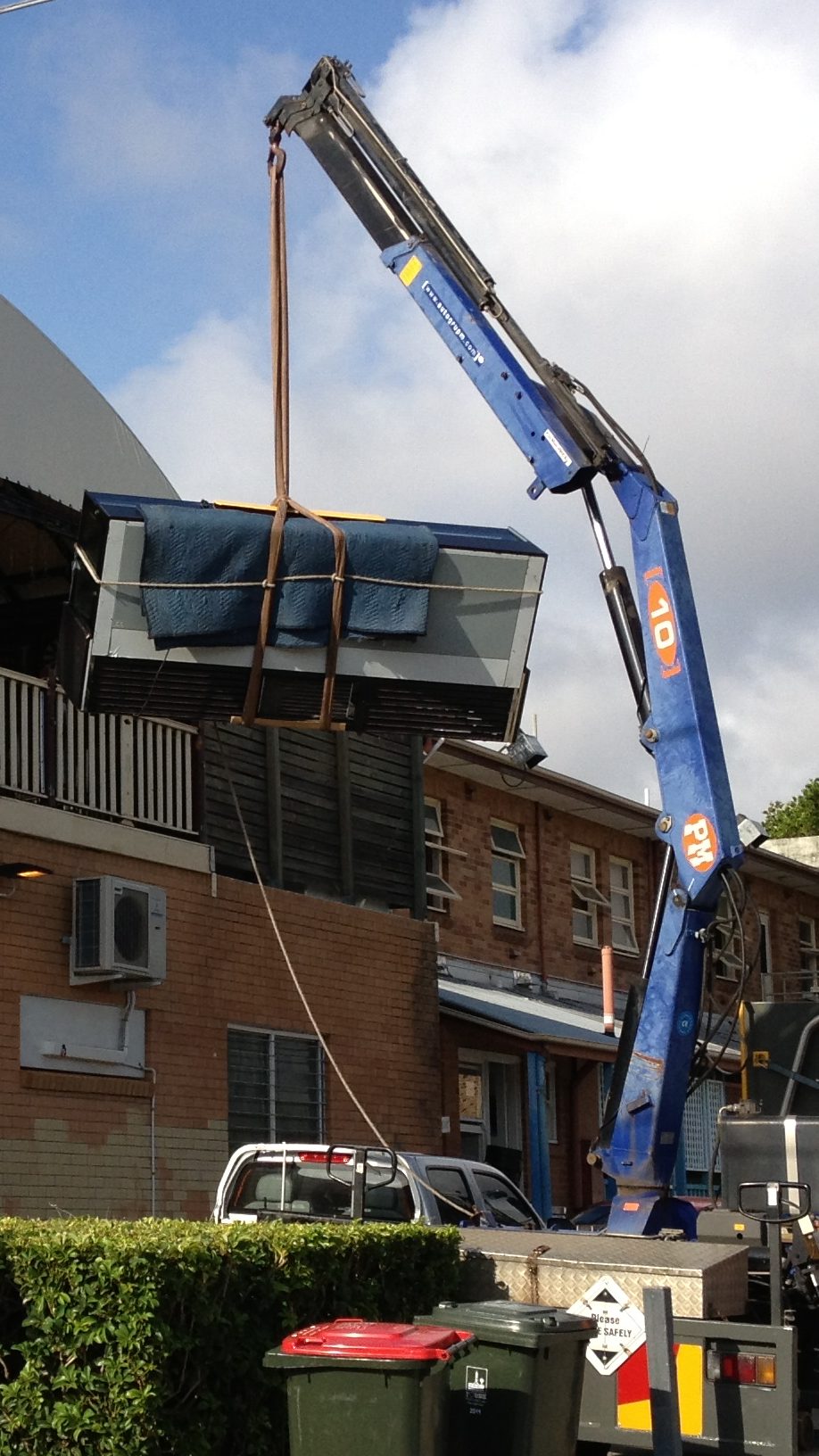 ice cream fridge being craned into building for installation