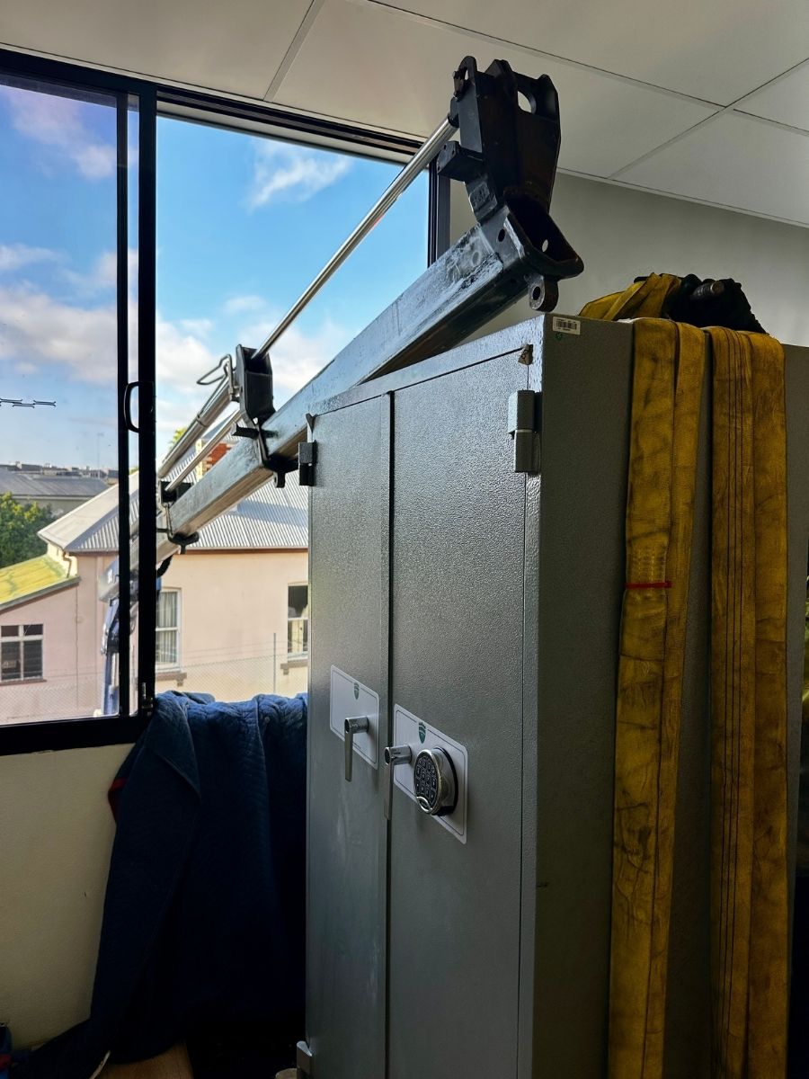 Large safe being relocated and craned into building